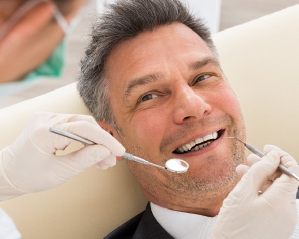 Man smiling at the dentist in Pacoima