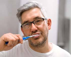 Man brushing teeth to prevent dental emergencies Pacoima