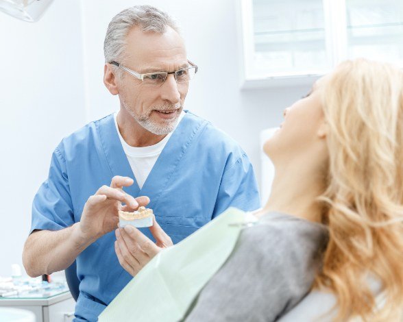 Dentist discussing full mouth reconstruction with dental patient